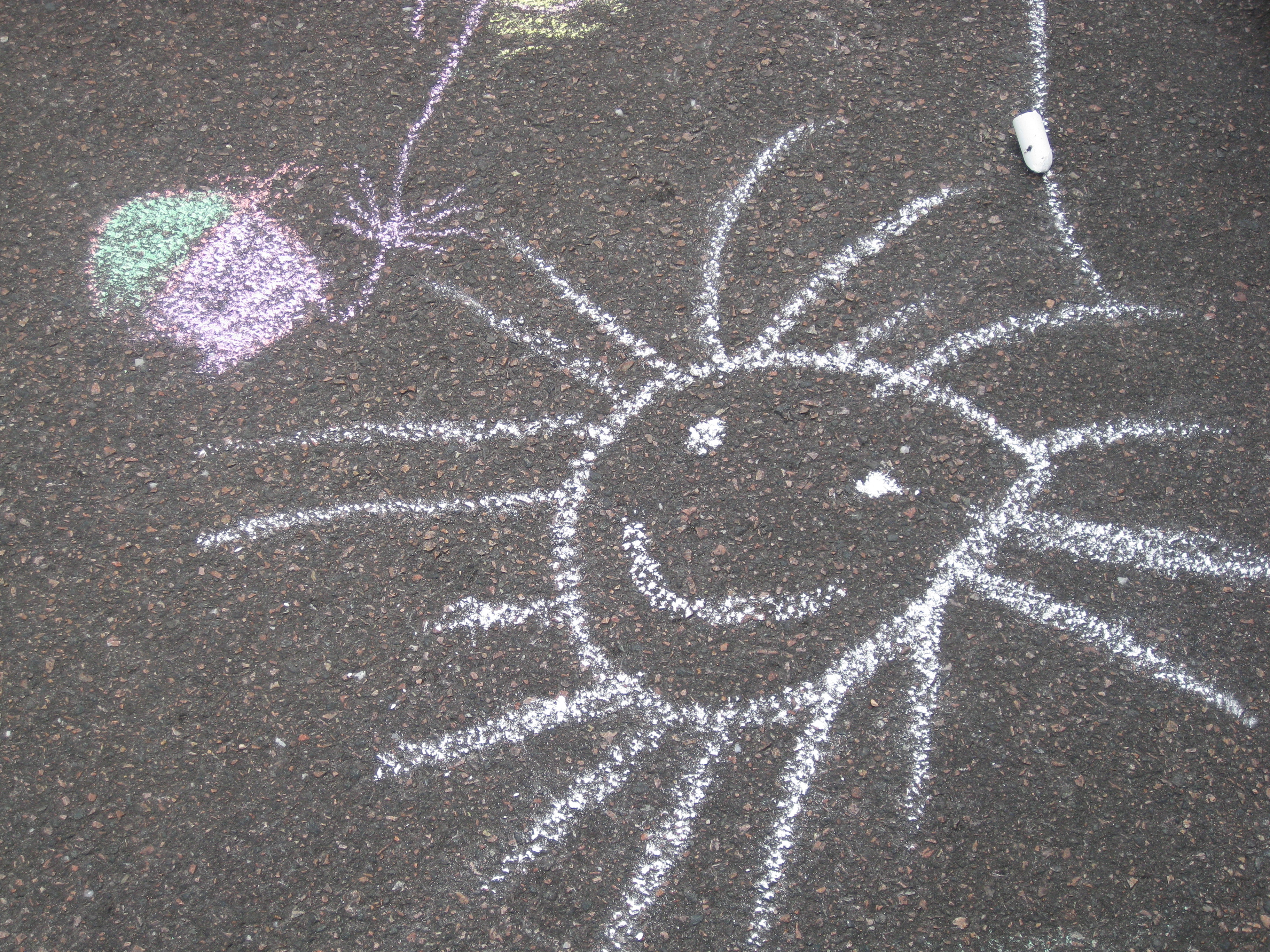 sol ritad med krita på asfalt