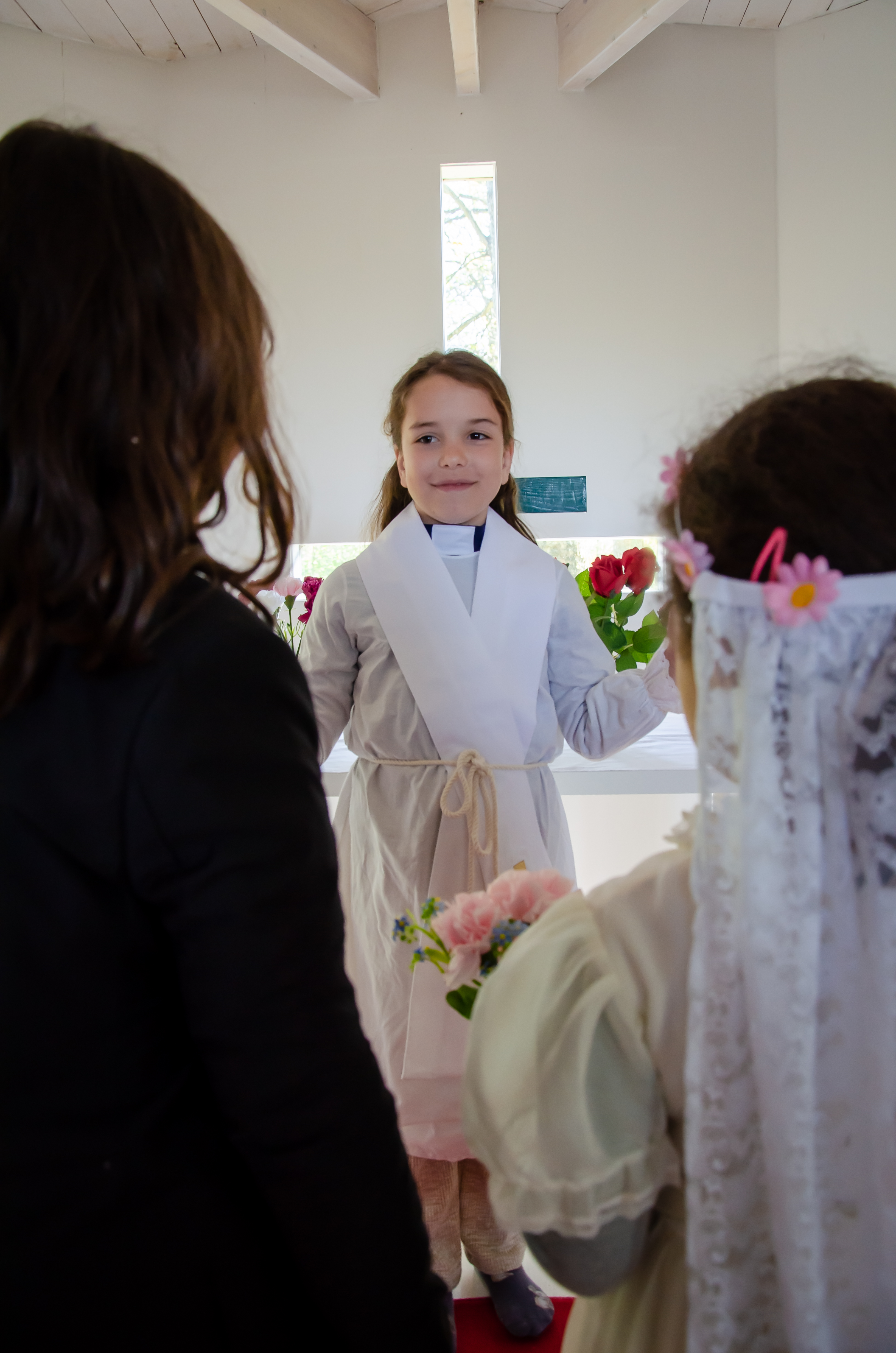 Tre barn leker vigsel, där två agerar vigselpar och en agerar präst.