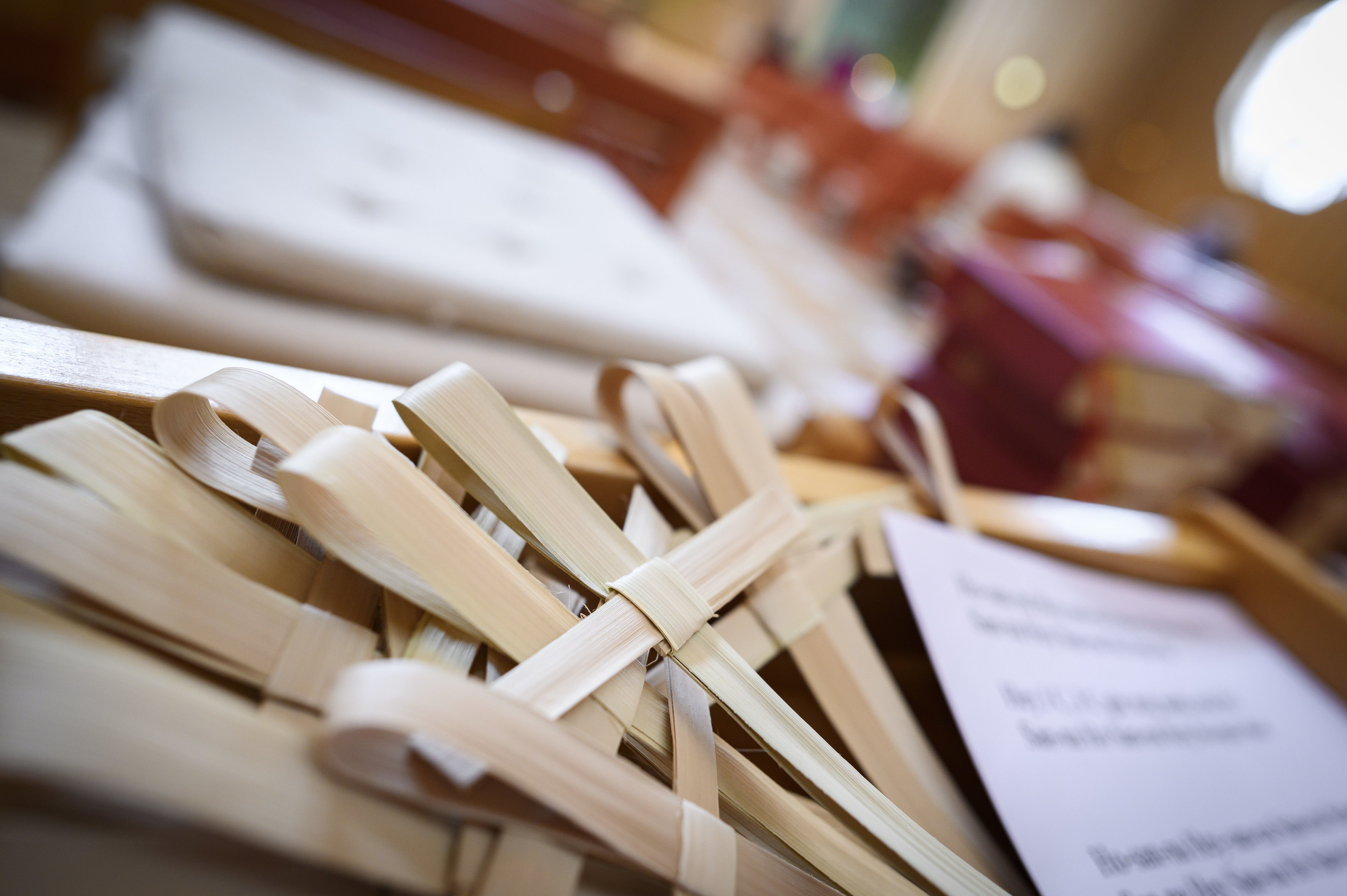 Små kors gjorda av palmblad ligger i en hög vid ingången till kyrkan.