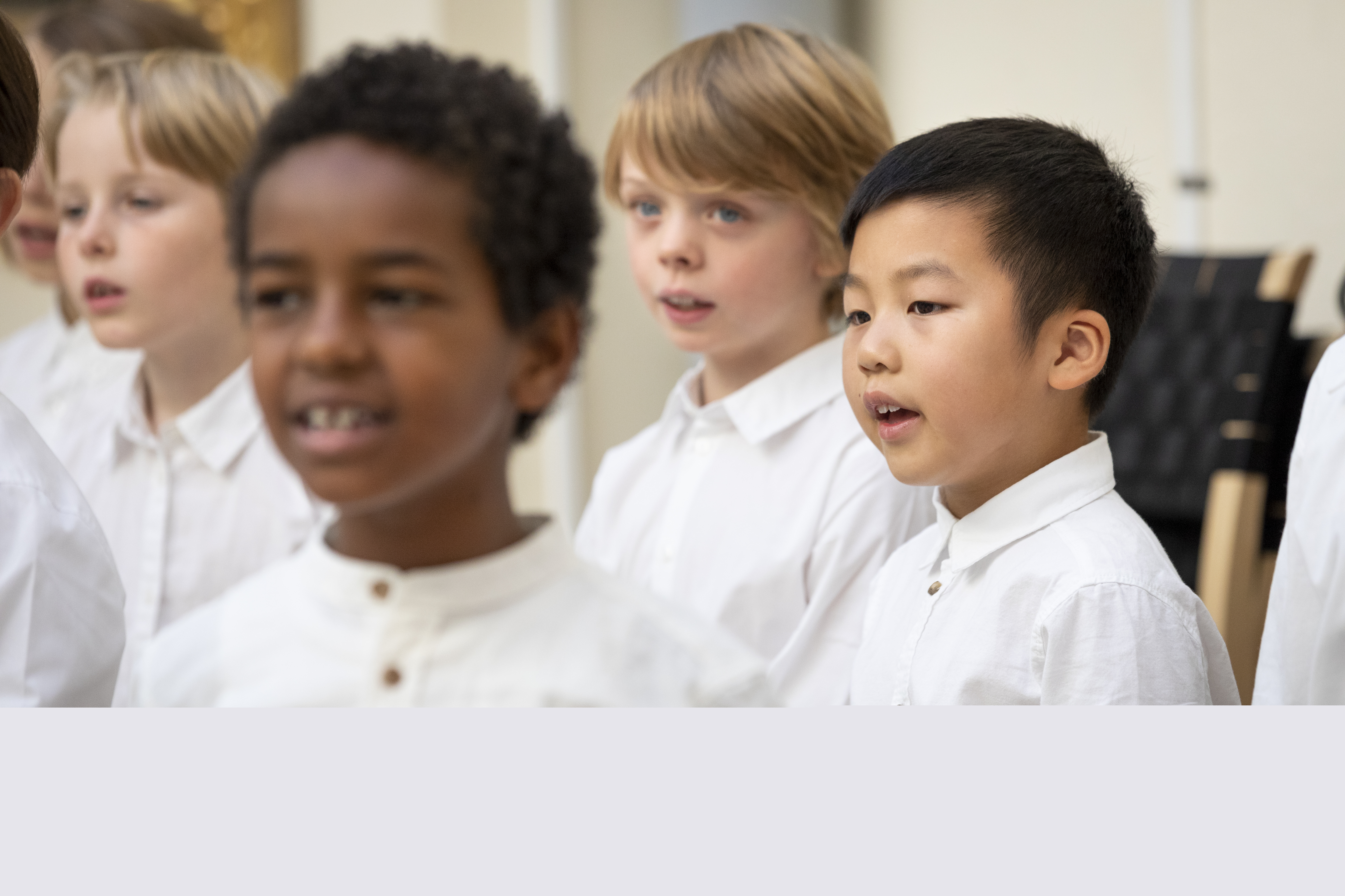 Medlemmar i en barnkör står och sjunger i en kyrka.